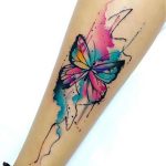 Single watercolor butterfly tattoo on forearm