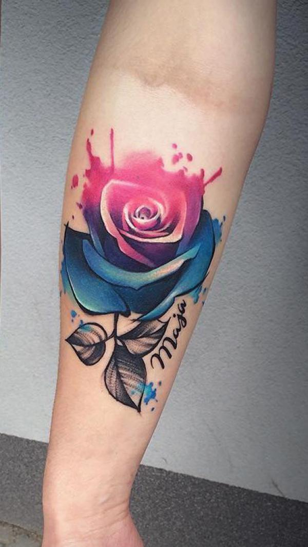 Single watercolor red and blue rose tattoo on forearm