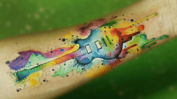 Watercolor Guitar arm tattoo