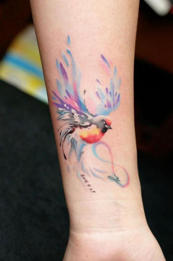 Watercolor bird forearm tattoo with date