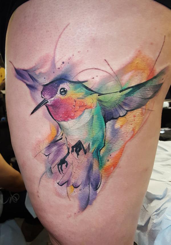 Watercolor hummingbird thigh tattoo
