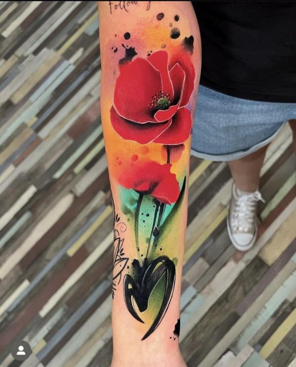 Watercolor poppy tattoo on forearm