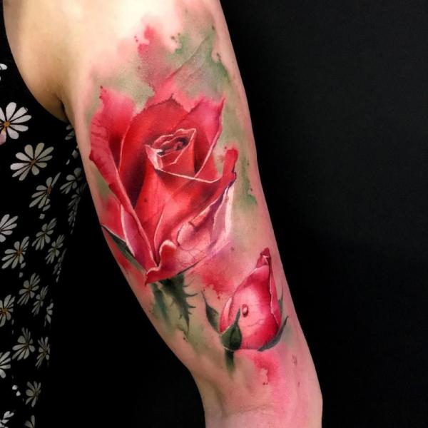 Watercolor red rose and bud tattoo on bicep