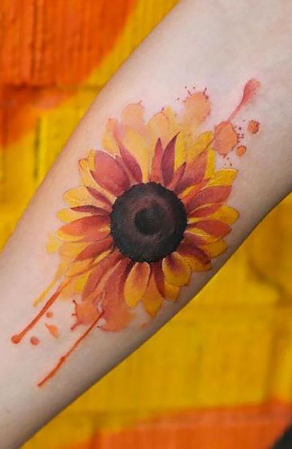 Watercolor sunflower tattoo on forearm