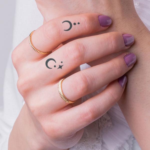 Crescent moon and star finger tattoo