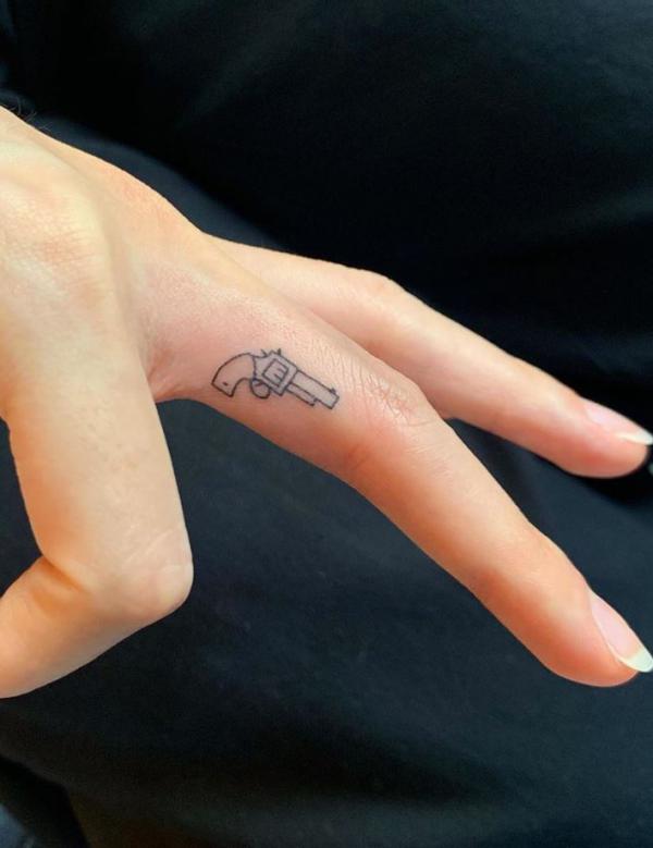 Finger gun tattoo