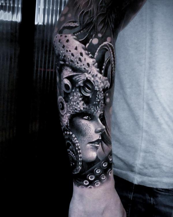 A female wearing octopus headdress forearm tattoo