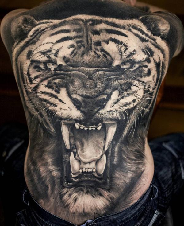 A large realistic tiger head full back tattoo