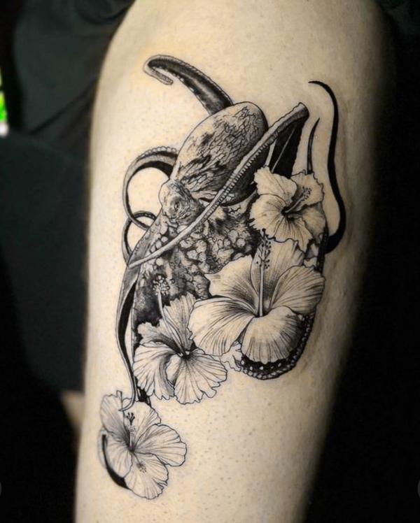Black and grey octopus and hibiscus tattoo
