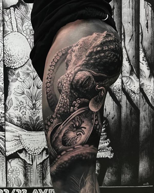 Black and grey octopus and human heart tattoo