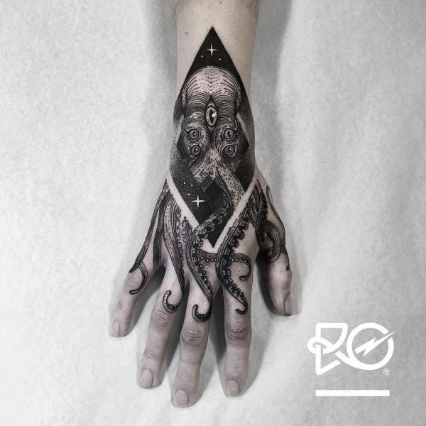 Blackwork octopus hand tattoo