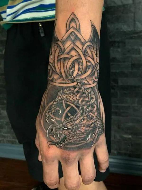 Celtic dragon hand tattoo
