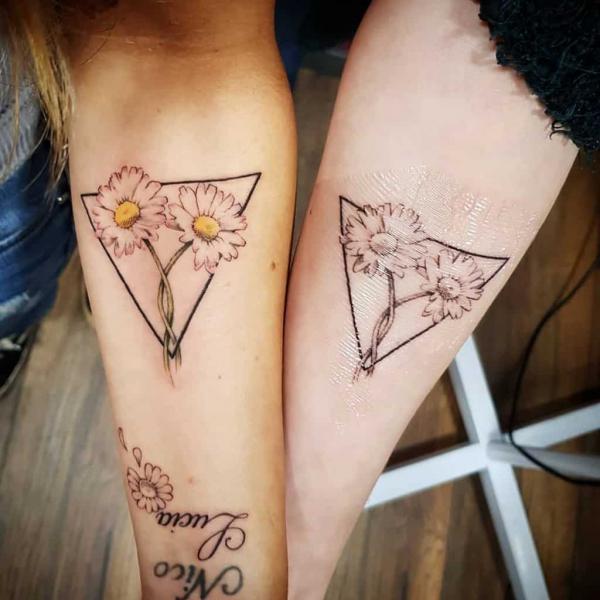 Geometric daisy matching tattoos for sisters