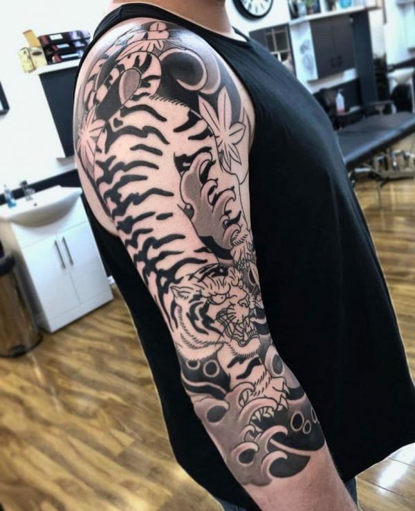 Japanese white tiger and waves sleeve tattoo