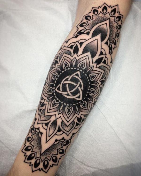 Mandala with celtic love symbol in the middle