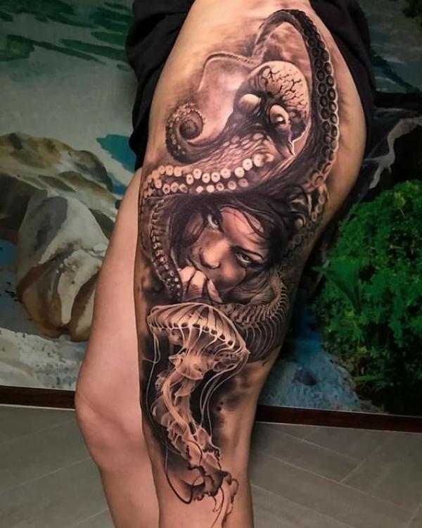 Octopus and jellyfish with a female face thigh tattoo