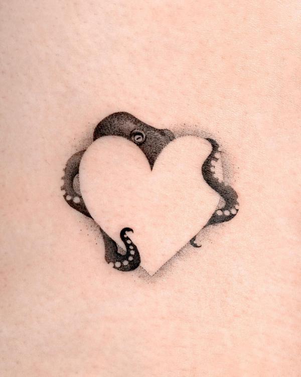 Octopus and negative space heart tattoo
