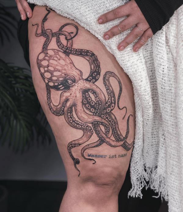 Octopus thigh tattoo with words Wasser ist nass