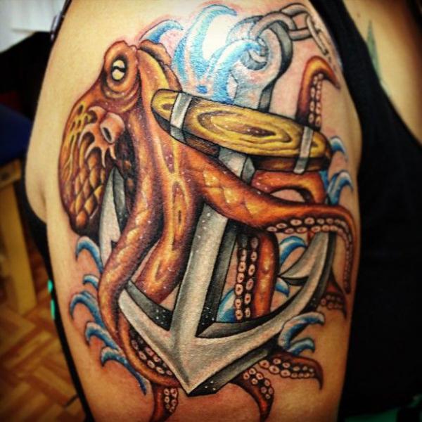 Octopus with anchor tattoo on upper arm