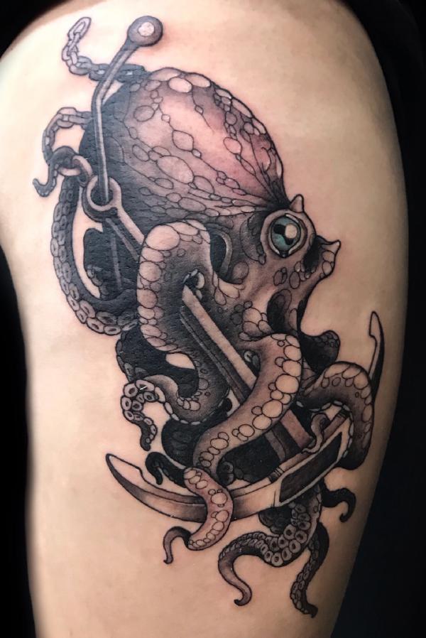 Octopus with anchor thigh tattoo
