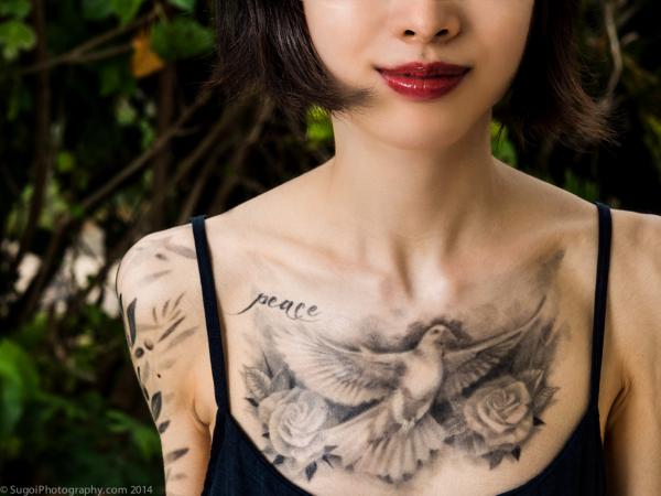 Peace dove chest tattoo with roses