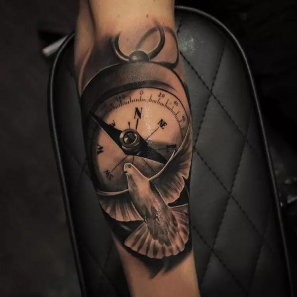 Realistic dove and compass tattoo