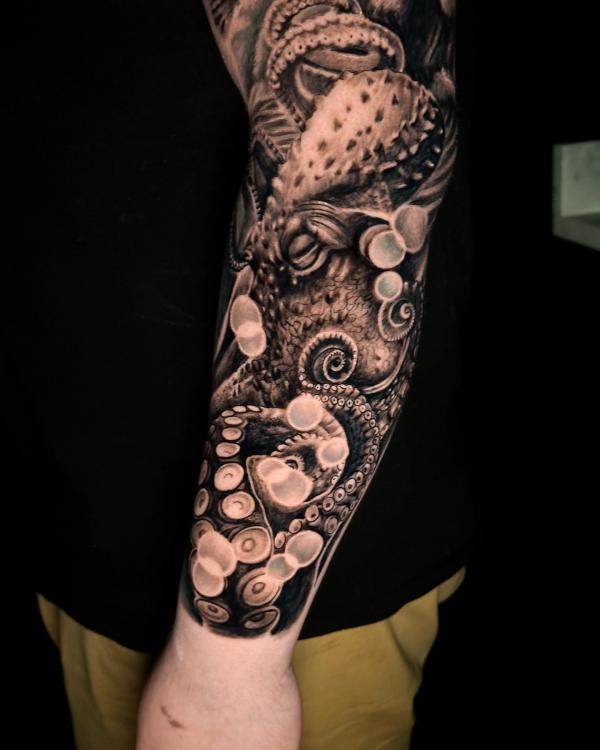 Realistic octopus arm tattoo