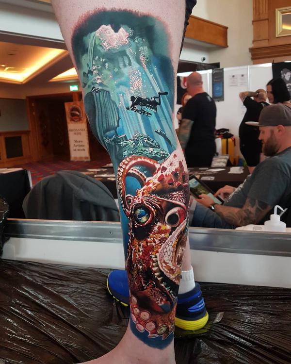 Realistic scuba diver and octopus leg tattoo