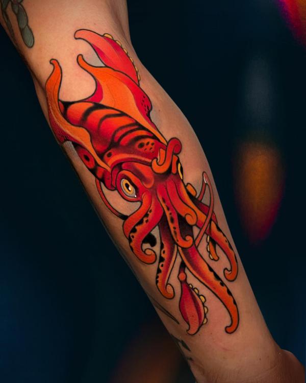 Red octopus forearm tattoo