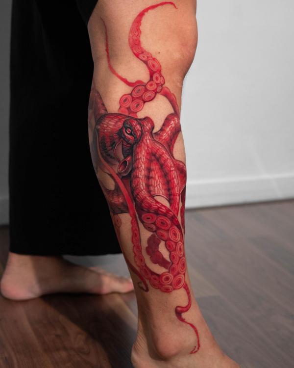 Red octopus lower leg tattoo