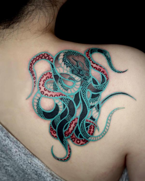 Stylized octopus shoulder blade tattoo