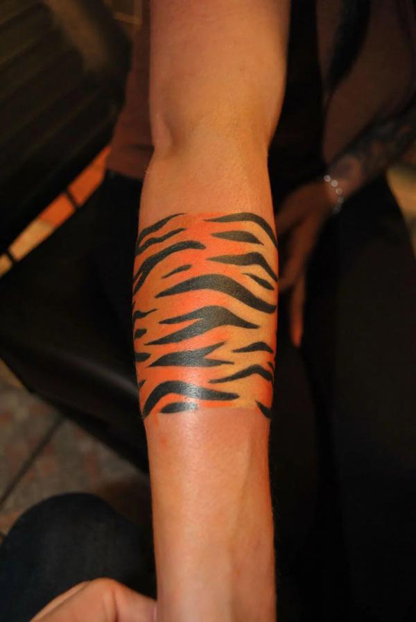 Tiger stripes forearm tattoo