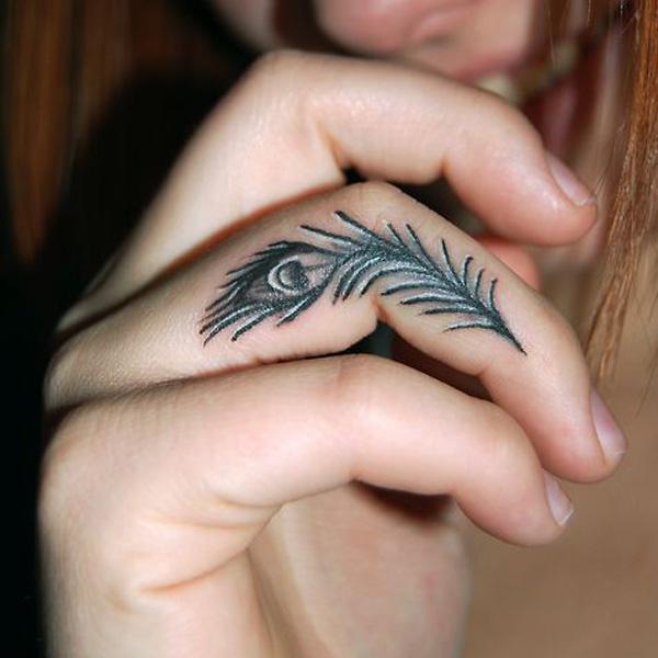 Tiny peacock feather Finger Tattoo