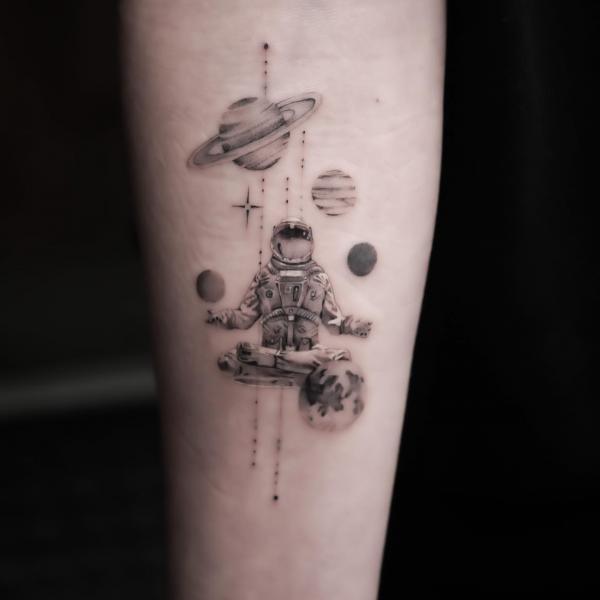 Black and grey Astronaut solar system tattoo