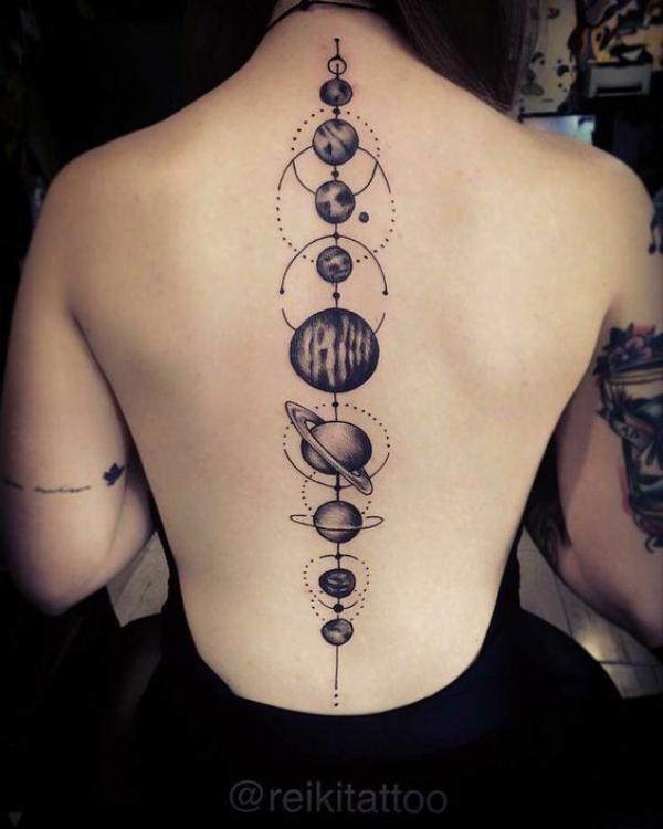 Black and white solar system spine tattoo