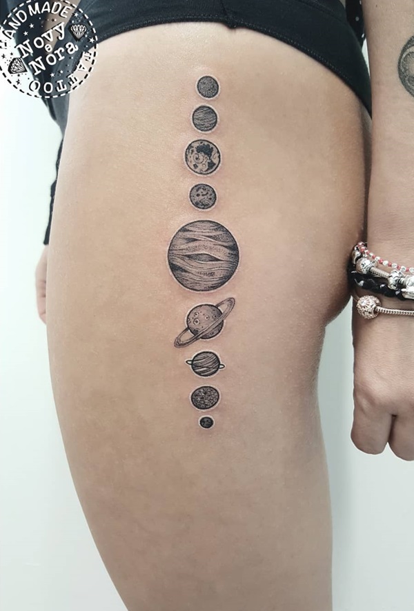 Black and white solar system thigh tattoo
