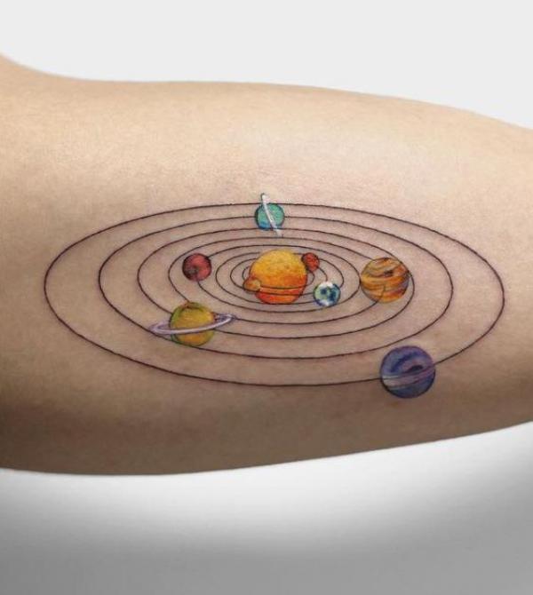 Circular solar system tattoo on upper arm