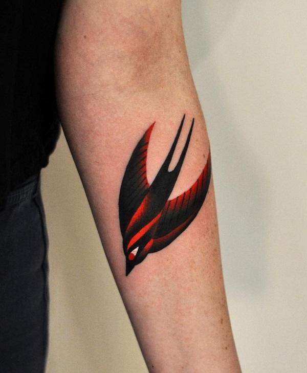 Black and red swallow tattoo forearm