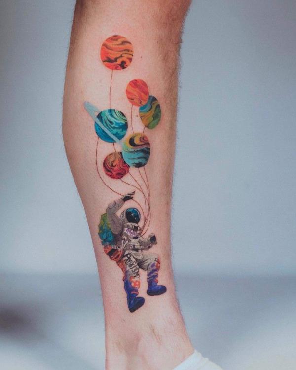 Colorful astronaut solar system tattoo