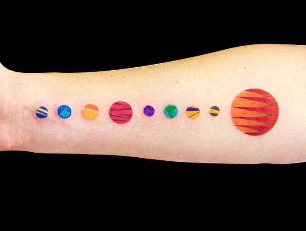 Colorful solar system tattoo forearm