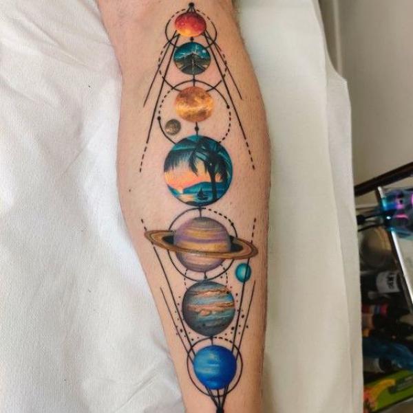 Colorful solar system tattoo on calf