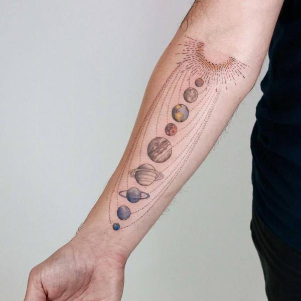 Half sun solar system forearm tattoo