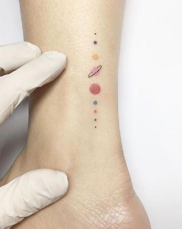 Minimalist solar system tattoo on ankle