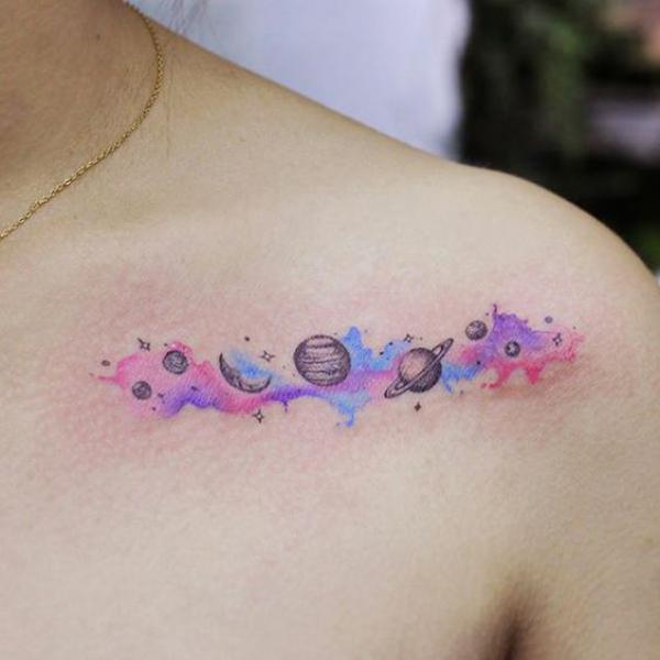 Small watercolor solar system clavicle tattoo