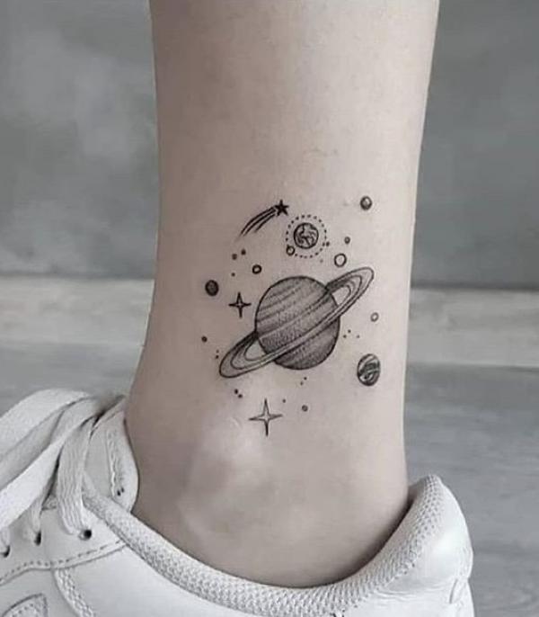 Solar system and shooting star tattoo on ankle