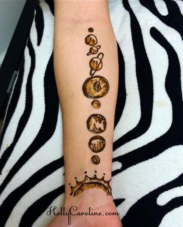 Solar system henna forearm tattoo