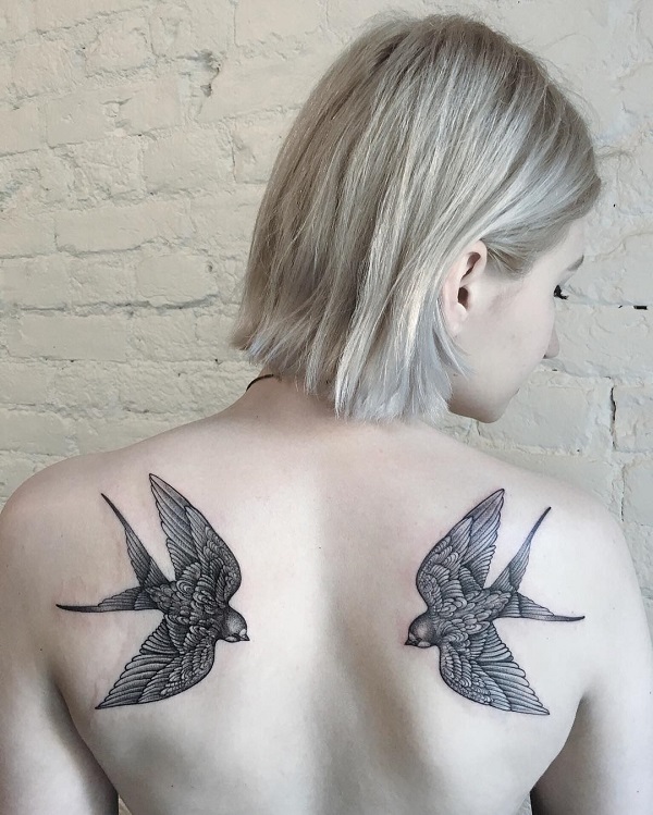 Black and grey Swallows back tattoo for girl