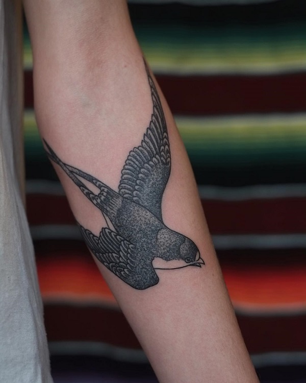 Black Swallow tattoo on forearm
