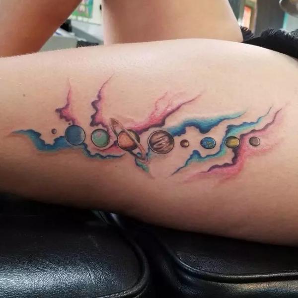Watercolor solar system outer forearm tattoo