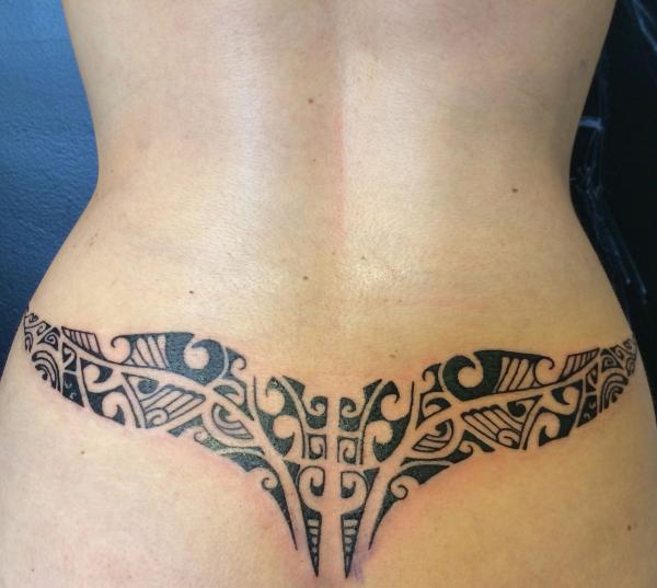 Low back tribal tattoo for women